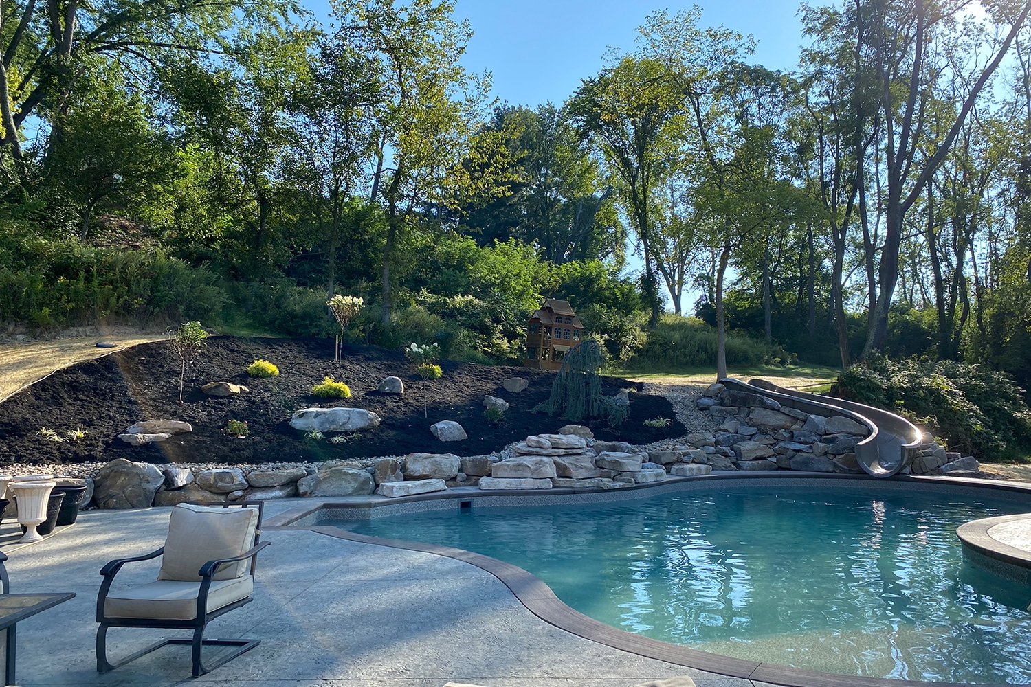 pool with rock retaining wall near it